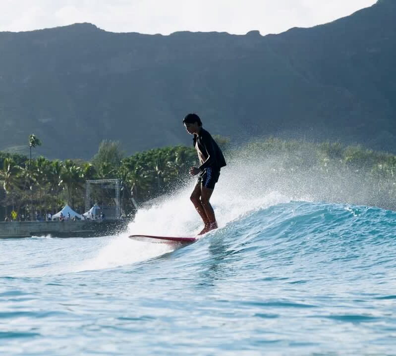 Another top surfer, surfing a wave in Oahu Hawaii